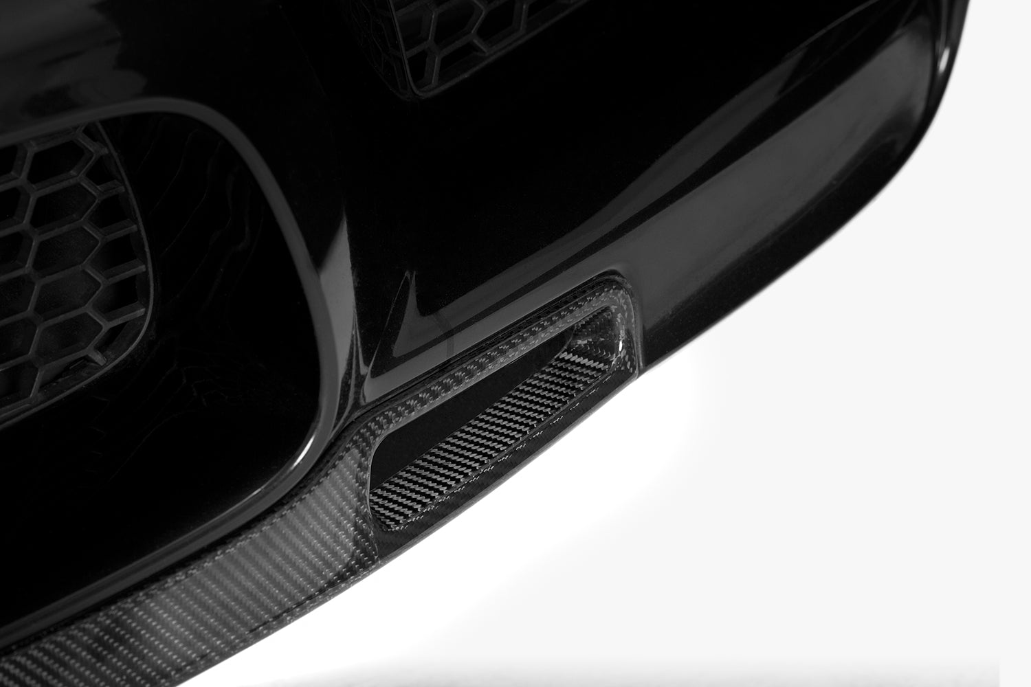 A section of the black splitter on the BMW M5 (F10).